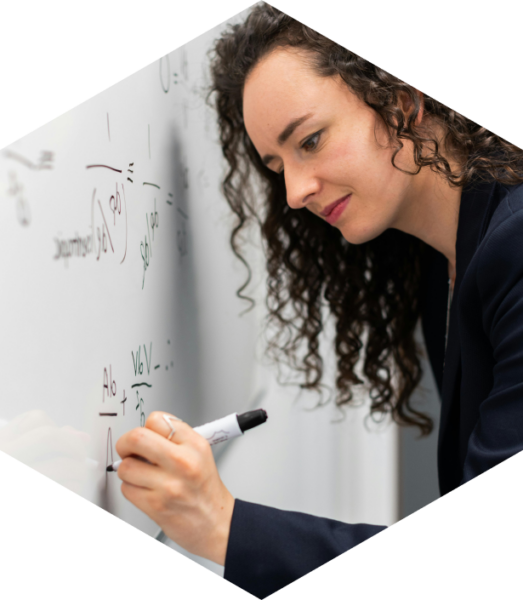 Woman writing down chemical equations on to whiteboard